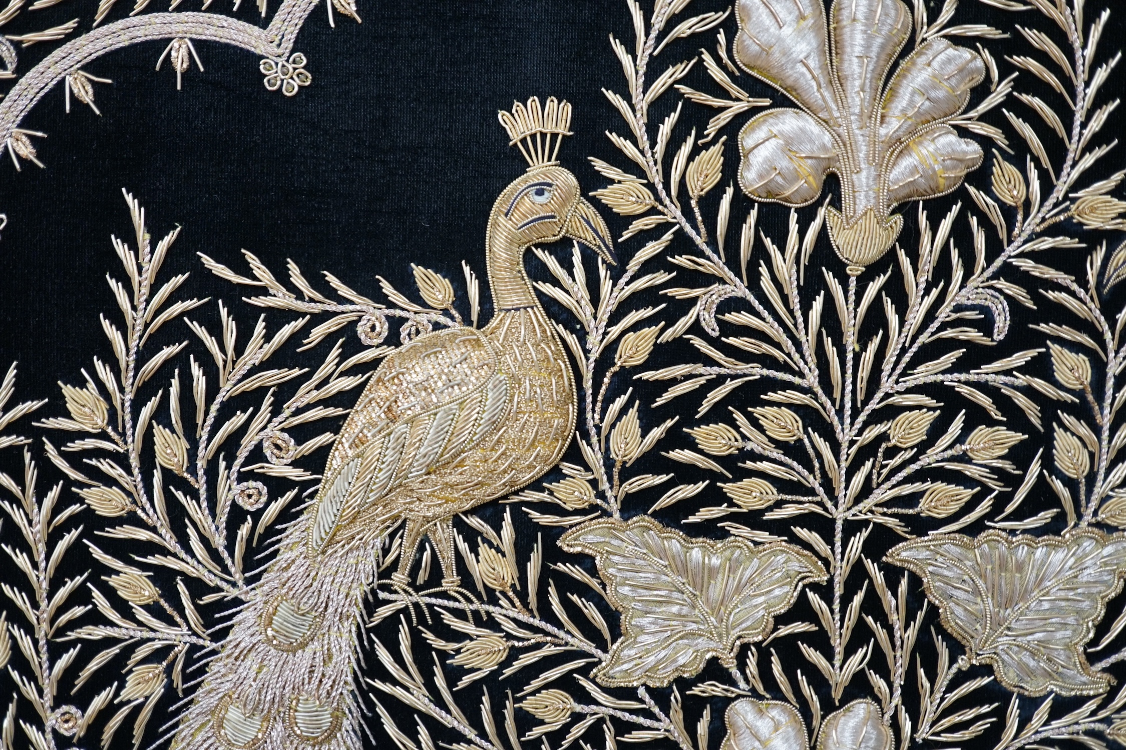 An Indian velvet and gold bullion work panel depicting two peacocks, 85 x 122cm. Condition - good